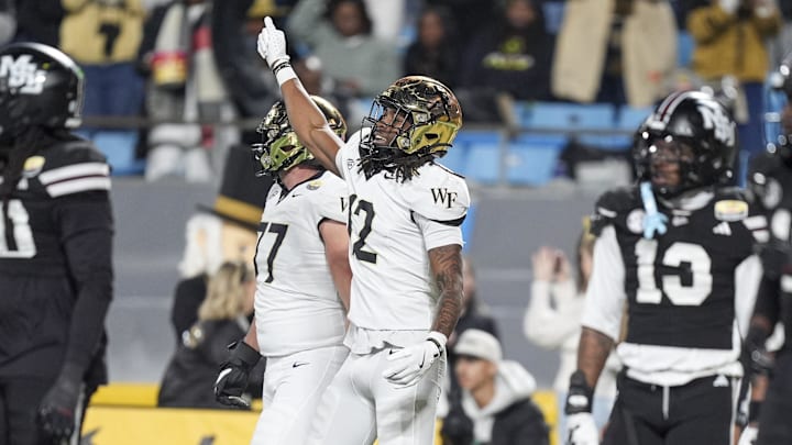 Wake Forest Demon Deacons defensive back Jaxon Mull (12) celebrates his score against the Mississippi State Bulldogs during the first quarter at Bank of America Stadium.