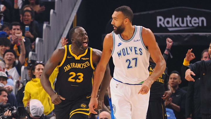 Nov 12, 2023; San Francisco, California, USA; Golden State Warriors forward Draymond Green (23) celebrates behind Minnesota Timberwolves center Rudy Gobert (27) after scoring a three point basket during the first quarter at Chase Center. Nov 12, 2023; San Francisco, California, USA; Golden State Warriors forward Draymond Green (23) celebrates behind Minnesota Timberwolves center Rudy Gobert (27) after scoring a three point basket during the first quarter at Chase Center.