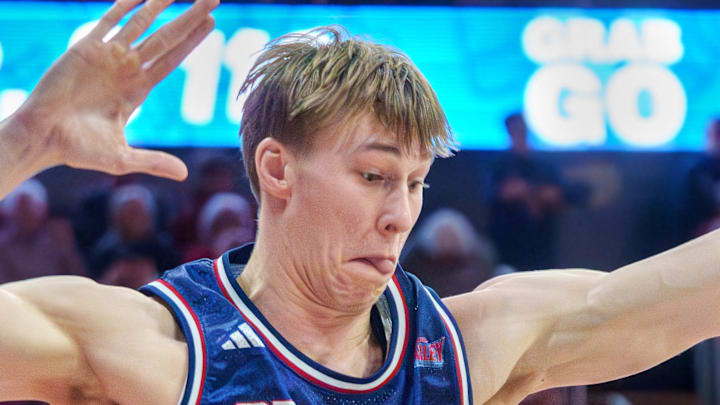 Belmont's Drew Scharnowski (11) and Isaiah West (3) guard Bradley's Jaquan Johnson in the first half of their college basketball game Monday, Feb. 9, 2026 at Carver Arena in Peoria. The Braves defeated the Bruins 95-84.