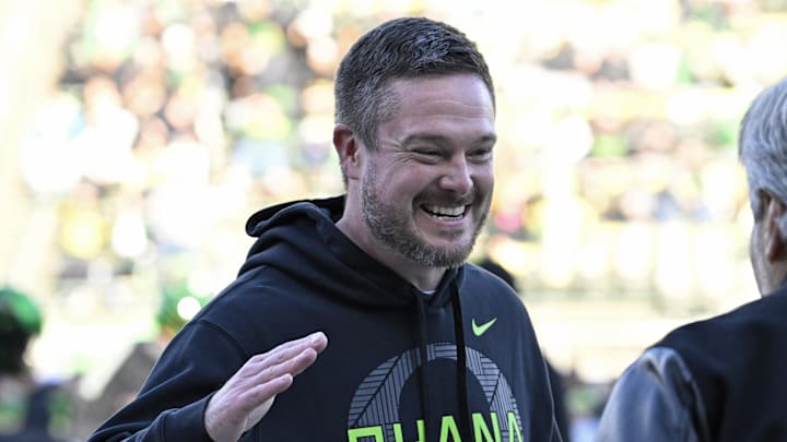 Nov 22, 2025; Eugene, Oregon, USA; Oregon Ducks head coach Dan Lanning smiles before the game against the Southern California Trojans at Autzen Stadium. Mandatory Credit: Troy Wayrynen-Imagn Images