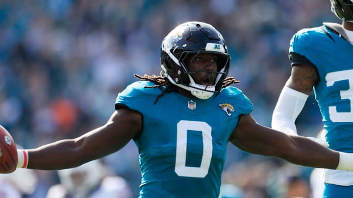 Jacksonville Jaguars linebacker Devin Lloyd (0) celebrates a fumble recovery with cornerback Montaric Brown (30) during the second quarter of an NFL football AFC Wild Card playoff matchup, Sunday, Jan. 11, 2026, in Jacksonville, Fla. [Corey Perrine/Florida Times-Union]