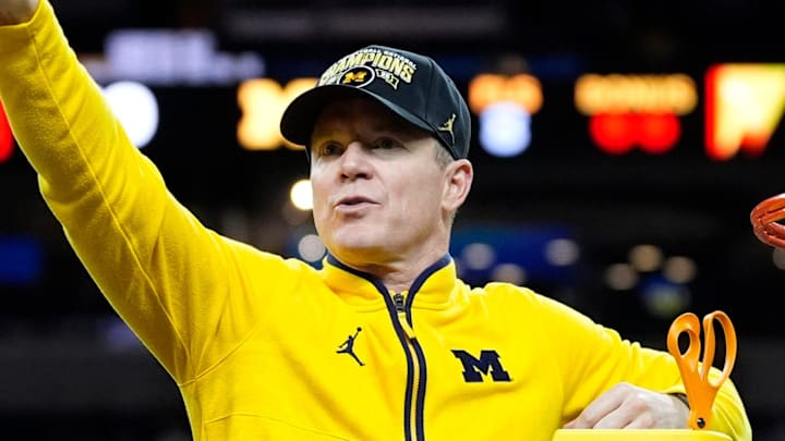 Michigan head coach Dusty May swings the net after winning the NCAA national championship against Connecticut at Lucas Oil Stadium in Indianapolis on Monday, April 6, 2026.