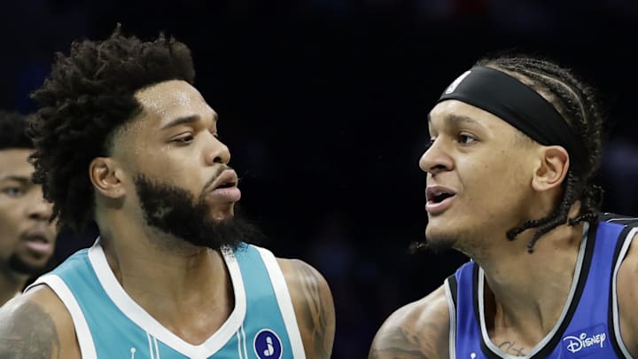 Orlando Magic forward Paolo Banchero tries to drive to the basket past Charlotte Hornets forward Miles Bridges.
