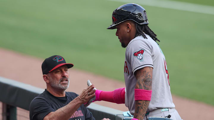 Jun 3, 2025; Atlanta, Georgia, USA; Arizona Diamondbacks second baseman Ketel Marte (4) celebrates with manager Torey Lovullo (17) after hitting a home run against the Atlanta Braves in the first inning at Truist Park. Mandatory Credit: Brett Davis-Imagn Images