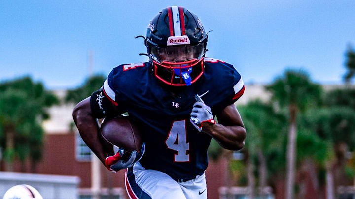 Lake Brantley's CJ Dewberry (4) runs in for one of his three rushing touchdowns against Oviedo, lifting the Patriots to a 47-37 victory on Friday night. Dewberry also scored on an 88-yard kickoff return for a TD,