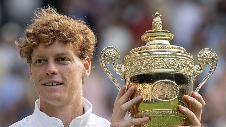 Jannik Sinner poses with the trophy after winning Wimbledon 2025