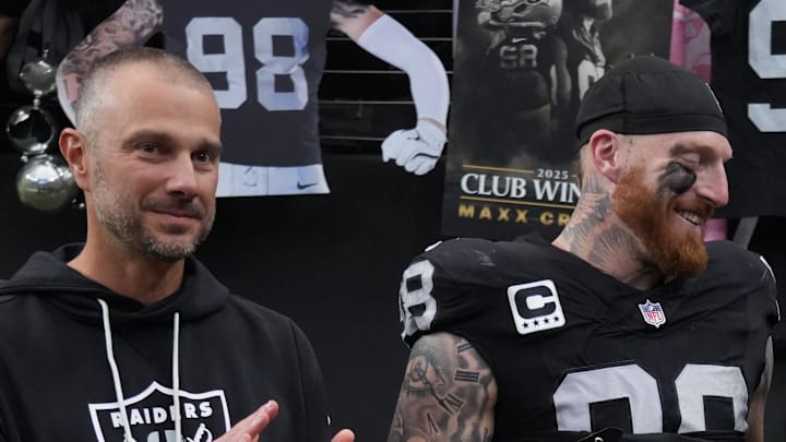 Dec 7, 2025; Paradise, Nevada, USA;  Las Vegas Raiders defensive end Maxx Crosby (98) along with his wife Rachel Washburn and daughter Ella Rose Crosby and Raiders general manager John Spytek receives the Walter Payton Man of the Year Award prior to a game against the Denver Broncos at Allegiant Stadium. Mandatory Credit: Kirby Lee-Imagn Images