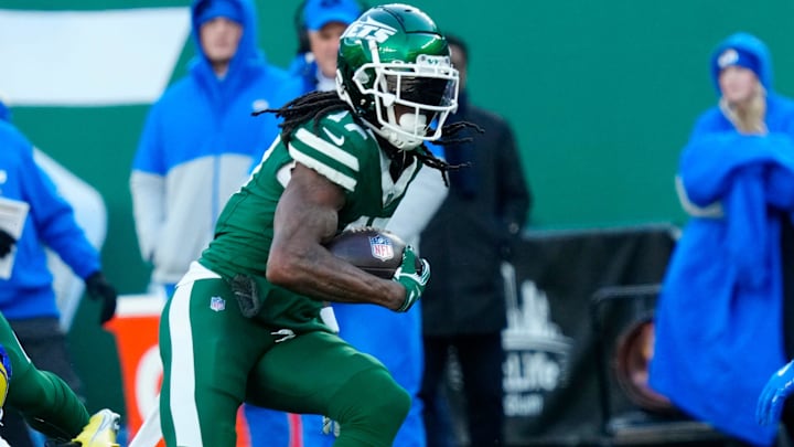 New York Jets wide receiver Allen Lazard (10) takes care of Los Angeles Rams cornerback Ahkello Witherspoon (4) as New York Jets wide receiver Davante Adams (17) continues with the ball after completing a pass for a first down in the second quarter, Sunday, December 22, 2024, in East Rutherford.