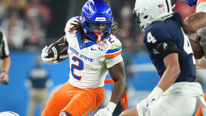 Boise State Broncos running back Ashton Jeanty (2) runs past Penn State Nittany Lions linebacker Kobe King (41) during their Vrbo Fiesta Bowl matchup at State Farm Stadium on Dec. 31, 2024.