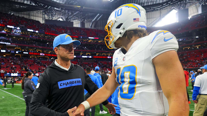 Dec 1, 2024; Atlanta, Georgia, USA; Los Angeles Chargers head coach Jim Harbaugh talks to quarterback Justin Herbert (10) after a victory over the Atlanta Falcons at Mercedes-Benz Stadium. Mandatory Credit: Brett Davis-Imagn Images Dec 1, 2024; Atlanta, Georgia, USA; Los Angeles Chargers head coach Jim Harbaugh talks to quarterback Justin Herbert (10) after a victory over the Atlanta Falcons at Mercedes-Benz Stadium. Mandatory Credit: Brett Davis-Imagn Images