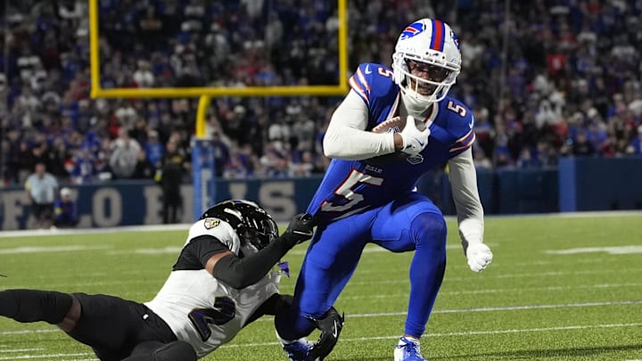 Joshua Palmer breaks a tackle against the Baltimore Ravens.