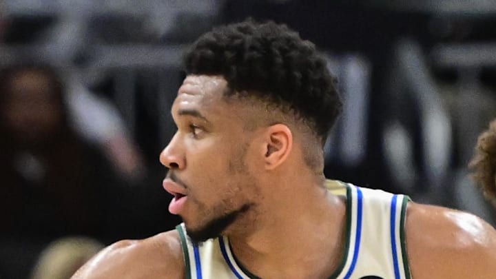 Milwaukee Bucks forward Giannis Antetokounmpo looks for a shot against Atlanta Hawks guard Dyson Daniels.