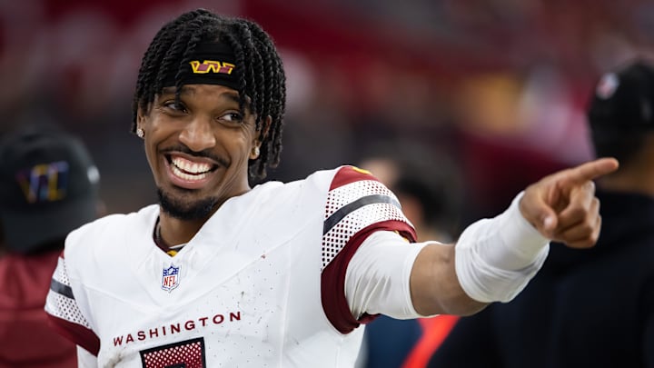 Sep 29, 2024; Glendale, Arizona, USA; Washington Commanders quarterback Jayden Daniels (5) celebrates in the closing seconds of the game against the Arizona Cardinals at State Farm Stadium. Mandatory Credit: Mark J. Rebilas-Imagn Images