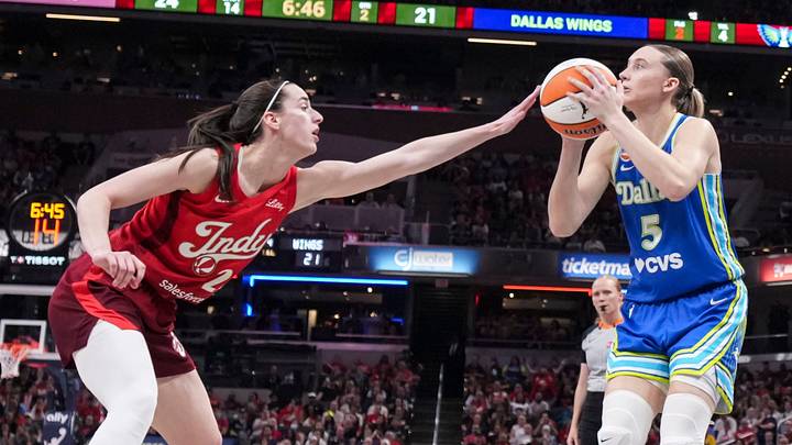 Dallas Wings guard Paige Bueckers (5) attempts a basket against Indiana Fever guard Caitlin Clark (22) Dallas Wings guard Paige Bueckers (5) attempts a basket against Indiana Fever guard Caitlin Clark (22)