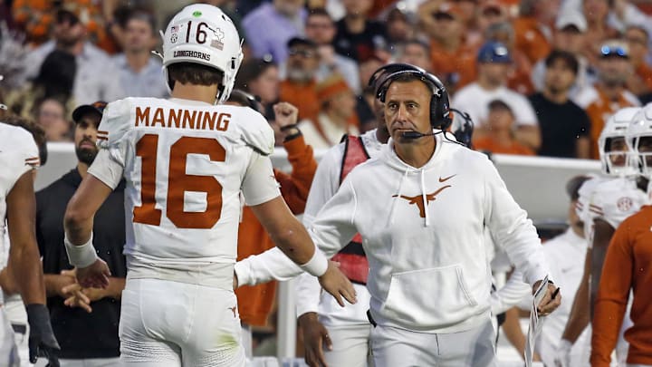 Oct 25, 2025; Starkville, Mississippi, USA; Texas Longhorns head coach Steve Sarkisian reacts with Texas Longhorns quarterback Arch Manning (16) during the fourth quarter against the Mississippi State Bulldogs at Davis Wade Stadium at Scott Field. Mandatory Credit: Petre Thomas-Imagn Images