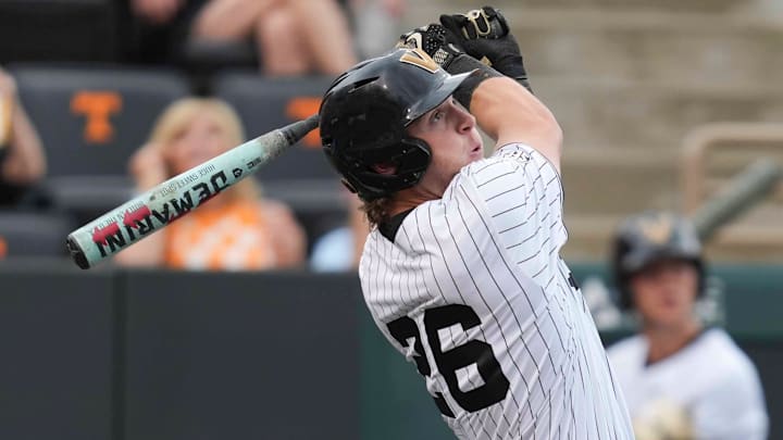 Vanderbilt infielder Braden Holcomb (26) hits the ball during a NCAA baseball game between the Tennessee Volunteers and Vanderbilt Commodores at Lindsey Nelson Stadium on May 11, 2025.