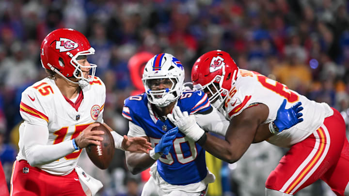 Nov 17, 2024; Orchard Park, New York, USA; Kansas City Chiefs quarterback Patrick Mahomes (15) is pressured by Buffalo Bills defensive end Greg Rousseau (50) who's being blocked by guard Trey Smith (65) in the third quarter at Highmark Stadium. Mandatory Credit: Mark Konezny-Imagn Images