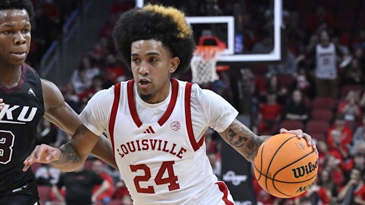 Dec 28, 2024; Louisville, Kentucky, USA;  Louisville Cardinals guard Chucky Hepburn (24) dribbles the ball against Eastern Kentucky Colonels guard George Kimble III (3) during the second half at KFC Yum! Center. Louisville won 78-76. 