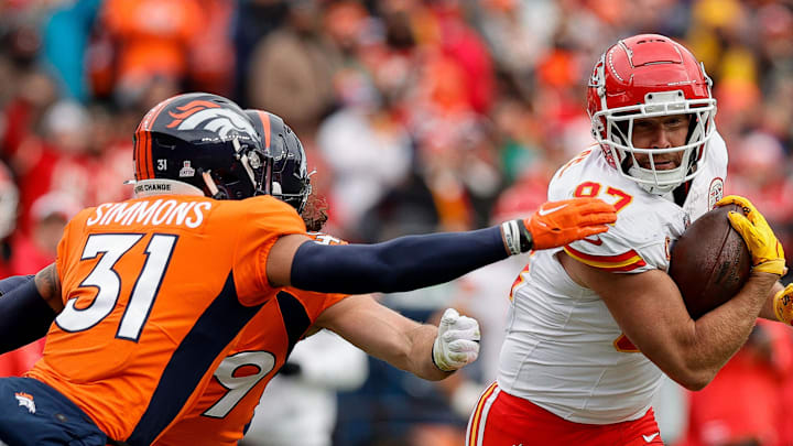 Oct 29, 2023; Denver, Colorado, USA; Kansas City Chiefs tight end Travis Kelce (87) runs the ball against Denver Broncos safety Justin Simmons (31) and linebacker Alex Singleton (49) in the second quarter at Empower Field at Mile High. Mandatory Credit: Isaiah J. Downing-Imagn Images | Isaiah J. Downing-Imagn Images