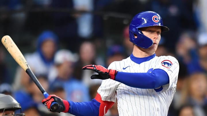 May 27, 2025; Chicago, Illinois, USA; Chicago Cubs center fielder Pete Crow-Armstrong (4) hits a sacrifice ground out RBI during the third inning against the Colorado Rockies at Wrigley Field. 