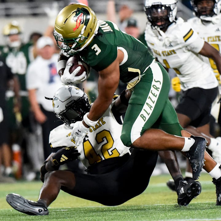 UAB running back Isaiah Jacobs fights for yards during a game last season. | Mickey Welsh / Advertiser / USA TODAY NETWORK via Imagn Images