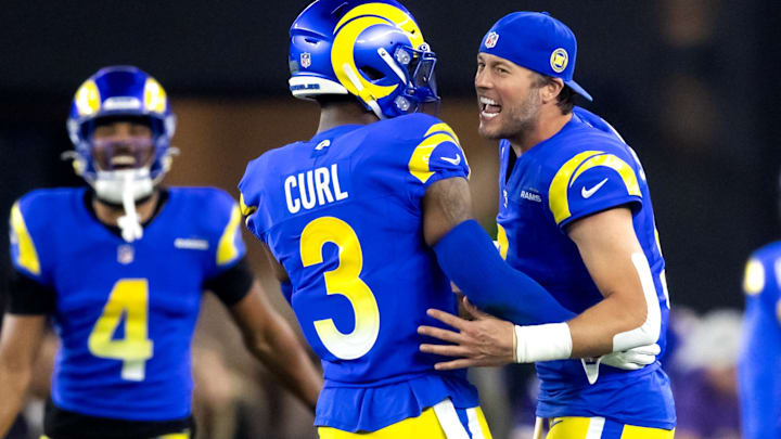 Jan 13, 2025; Glendale, AZ, USA; Los Angeles Rams quarterback Matthew Stafford (9) celebrates a touchdown with safety Kamren Curl (3) against the Minnesota Vikings during an NFC wild card game at State Farm Stadium. Mandatory Credit: Mark J. Rebilas-Imagn Images