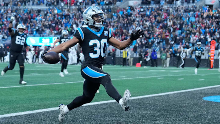 Dec 22, 2024; Charlotte, North Carolina, USA; Carolina Panthers running back Chuba Hubbard (30) scores in overtime to win the gqme at Bank of America Stadium. Mandatory Credit: Bob Donnan-Imagn Images Dec 22, 2024; Charlotte, North Carolina, USA; Carolina Panthers running back Chuba Hubbard (30) scores in overtime to win the gqme at Bank of America Stadium. Mandatory Credit: Bob Donnan-Imagn Images