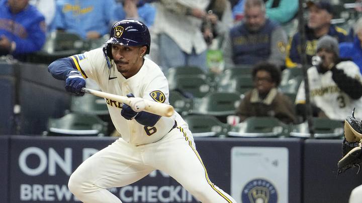 Apr 1, 2026; Milwaukee, Wisconsin, USA;  Milwaukee Brewers second baseman David Hamilton (6) bunts the ball against the Tampa Bay Rays for hit on an errand throw in the third inning at American Family Field. Mandatory Credit: Michael McLoone-Imagn Images