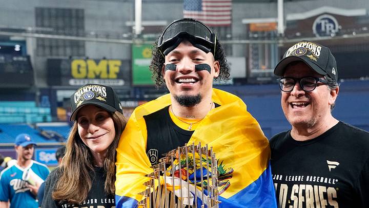 Milwaukee Brewers catcher William Contreras (24) takes a photo with Brewers owner Mark Attanasio, right, and his wife Debbie Attanasio, left, after winning the World Series against the Tampa Bay Rays at Tropicana Field on in St.Petersburg, Florida on Oct. 28, 2026.