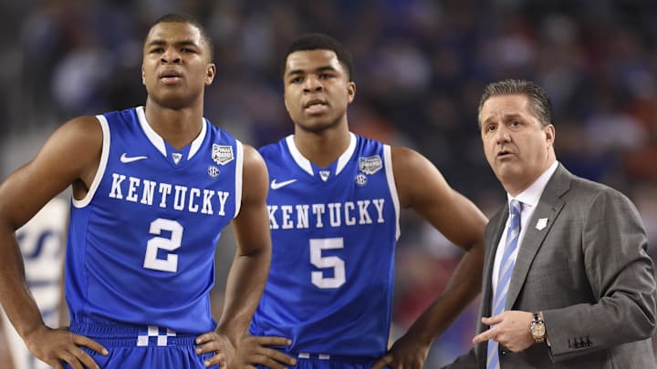 Apr 5, 2014; Arlington, TX, USA; Kentucky Wildcats head coach John Calipari talks to guard Andrew Harrison (5) and Aaron Harrison (2) on the sideline against the Wisconsin Badgers in the first half during the semifinals of the Final Four in the 2014 NCAA Mens Division I Championship tournament at AT&T Stadium. Mandatory Credit: Bob Donnan-Imagn Images