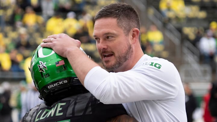 Oregon head coach Dan Lanning, right, embraces Oregon wide receiver Justius Lowe before the game as the Oregon Ducks host the Indiana Hoosiers Oct. 11, 2025, at Autzen Stadium in Eugene, Oregon.