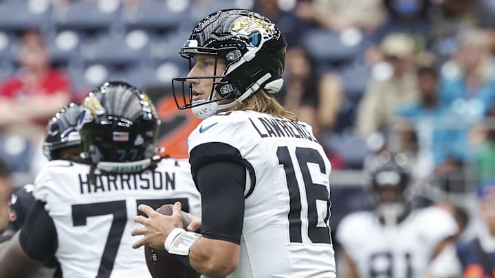 Sep 29, 2024; Houston, Texas, USA; Jacksonville Jaguars quarterback Trevor Lawrence (16) looks for an open receiver during the first quarter against the Houston Texans at NRG Stadium. Mandatory Credit: Troy Taormina-Imagn Images