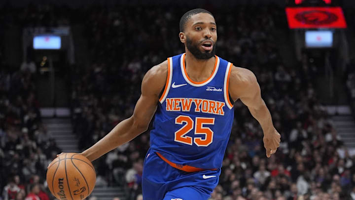 Jan 28, 2026; Toronto, Ontario, CAN; New York Knicks guard Mikal Bridges (25) dribbles the ball against Toronto Raptors guard Ja'Kobe Walter (14) during the first half at Scotiabank Arena. Mandatory Credit: John E. Sokolowski-Imagn Images