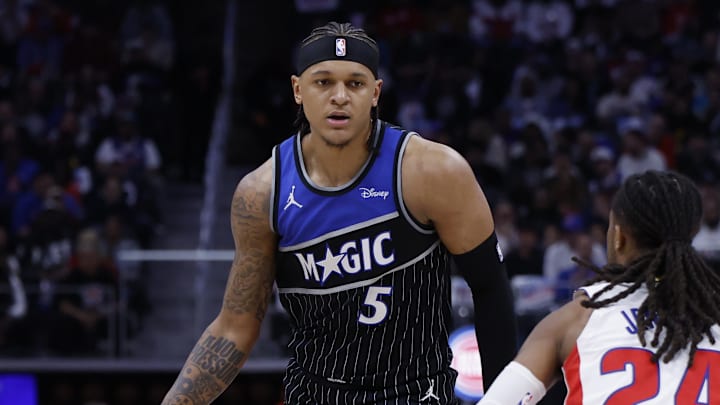 Apr 29, 2026; Detroit, Michigan, USA; Orlando Magic forward Paolo Banchero (5) is defended by Detroit Pistons guard Daniss Jenkins (24) in the first half during game five of the first round of the 2026 NBA Playoffs at Little Caesars Arena. Mandatory Credit: Rick Osentoski-Imagn Images