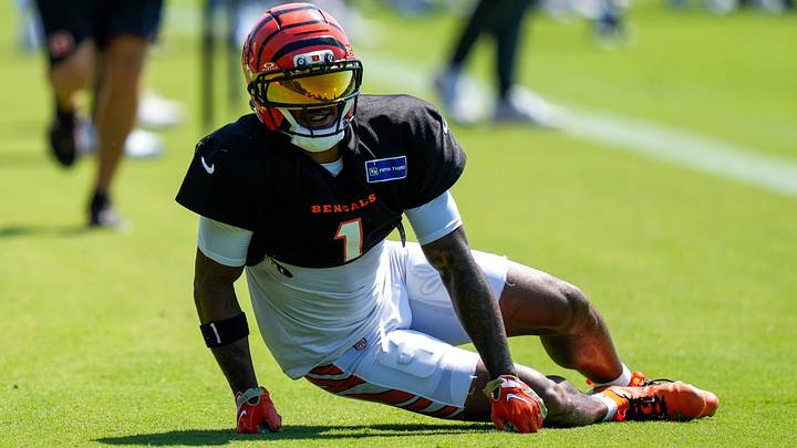 Cincinnati Bengals wide receiver Ja'marr Chase (1) takes a seat as he’s examined by the training staff after a collision with cornerback DJ Turner II (0) during Bengals training camp practice at the Paycor Stadium practice facility in downtown Cincinnati on Tuesday, Aug. 25, 2026.
