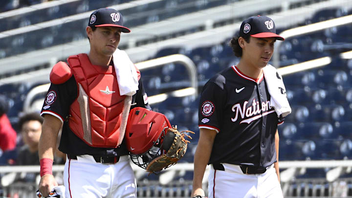 Sep 1, 2025; Washington, District of Columbia, USA; Washington Nationals catcher CJ Stubbs (left) and starting pitcher Andrew Alvarez (54) walk to the dugout before the game against the Miami Marlins at Nationals Park