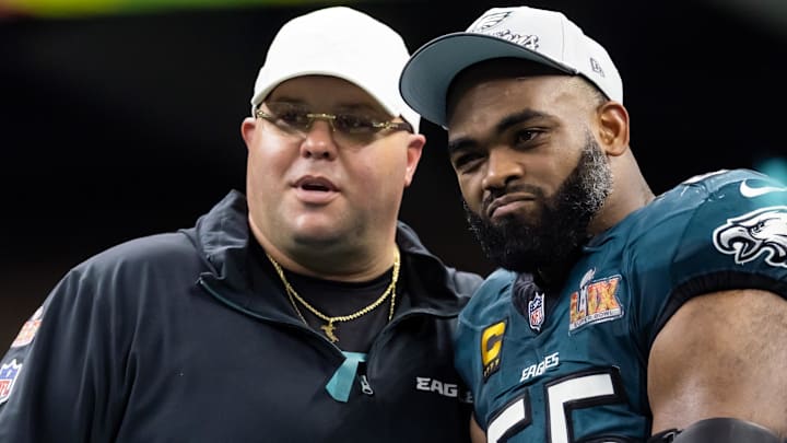 Feb 9, 2025; New Orleans, LA, USA; Philadelphia Eagles defensive end Brandon Graham (55) with team security guard Dom DiSandro after defeating the Kansas City Chiefs during Super Bowl LIX at Ceasars Superdome.