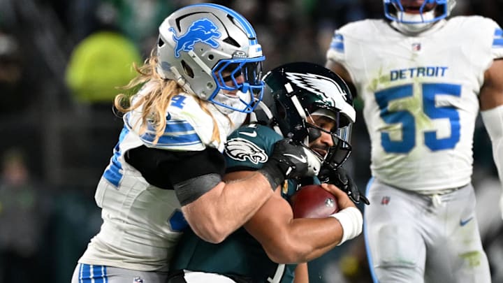 Detroit Lions linebacker Alex Anzalone (34) tackles Philadelphia Eagles quarterback Jalen Hurts (1) 