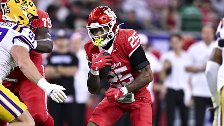 Dec 27, 2025; Houston, TX, USA; Houston Cougars running back DJ Butler (25) runs the ball during the first half against the Louisiana State Tigers at NRG Stadium. Mandatory Credit: Maria Lysaker-Imagn Images 