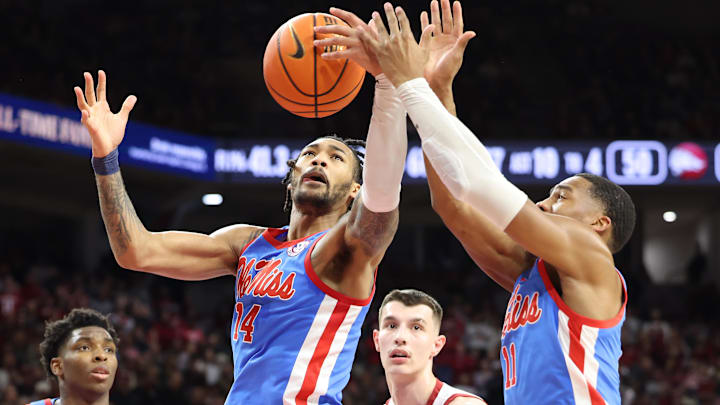 Ole Miss Rebels guards Dre Davis (14) and Matthew Murrell (11) reach for rebound as forward Malik Dia (0) and Arkansas Razorbacks forward Zvonimir Ivisic (44) look on in the second half at Bud Walton Arena. Ole Miss won 73-66.