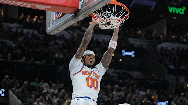 Dec 31, 2025; San Antonio, Texas, USA;  New York Knicks guard Jordan Clarkson (00) dunks in front of San Antonio Spurs forward Kelly Olynyk (8) in the second half at Frost Bank Center. Mandatory Credit: Daniel Dunn-Imagn Images