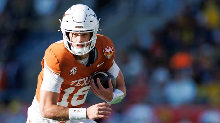 Dec 31, 2025; Orlando, FL, USA; Texas Longhorns quarterback Arch Manning (16) runs with the ball against the Michigan Wolverines during the first half at Camping World Stadium. Mandatory Credit: Matt Pendleton-Imagn Images