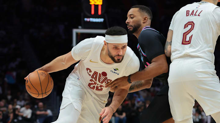 Nov 12, 2025; Miami, Florida, USA; Cleveland Cavaliers forward Larry Nance Jr. (22) drives to the basket against Miami Heat guard Norman Powell (24) during the second quarter at Kaseya Center. Mandatory Credit: Sam Navarro-Imagn Images
