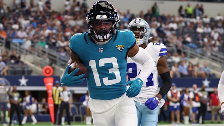 Aug 12, 2023; Arlington, Texas, USA; Jacksonville Jaguars wide receiver Christian Kirk (13) catches a touchdown pass in the first quarter against the Dallas Cowboys at AT&T Stadium. Mandatory Credit: Tim Heitman-Imagn Images