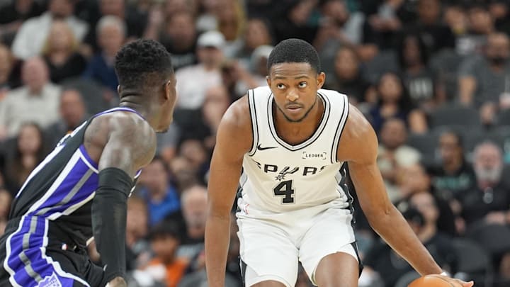 Nov 16, 2025; San Antonio, Texas, USA; San Antonio Spurs guard De'Aaron Fox (4) dribbles in front of Sacramento Kings guard Dennis Schroder (17) in the first half at Frost Bank Center.