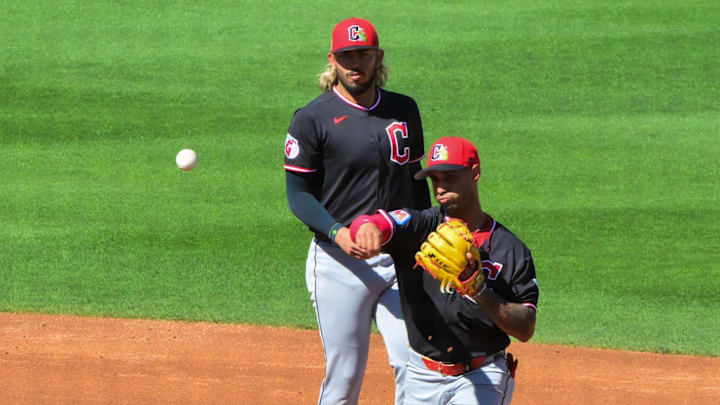 Feb 27, 2026; Mesa, Arizona, USA; Cleveland Guardians shortstop Gabriel Arias (13) and second baseman Brayan Rocchio (4) turn a double play as Chicago Cubs left fielder Dylan Carlson (5) is out at second base in the third inning at Sloan Park. Mandatory Credit: Matt Kartozian-Imagn Images