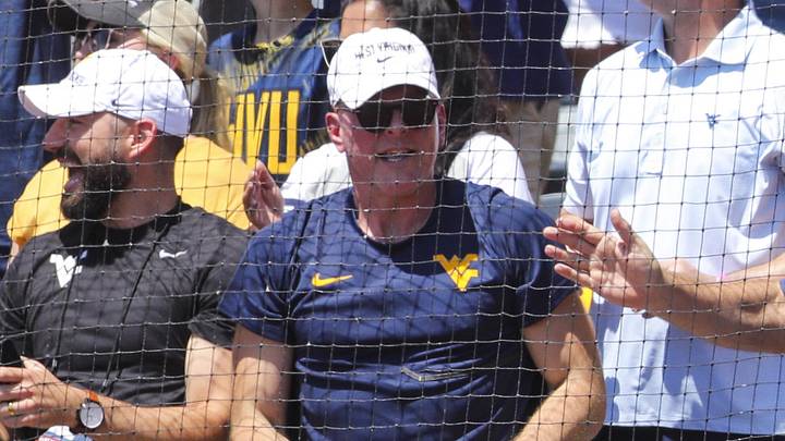 Jun 5, 2026; Morgantown, WV, USA; ESPN commentator Pat McAfee cheers with West Virginia Mountaineers head football coach Rich Rodriguez during the first inning against the Cal Poly Mustangs at Kendrick Family Ballpark. Mandatory Credit: Ben Queen-Imagn Images
