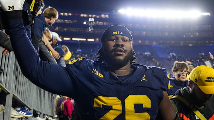 Michigan defensive lineman Rayshaun Benny (26) high-fives fans after 21-16 win over Purdue at Michigan Stadium in Ann Arbor on Saturday, November 1, 2025.