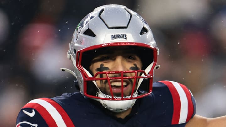 Christian Elliss #53 of the New England Patriots reacts after an interception by teammate Craig Woodson #31 in the first half against the Houston Texans during an AFC Divisional Playoff game at Gillette Stadium on January 18, 2026 in Foxborough, Massachusetts.
