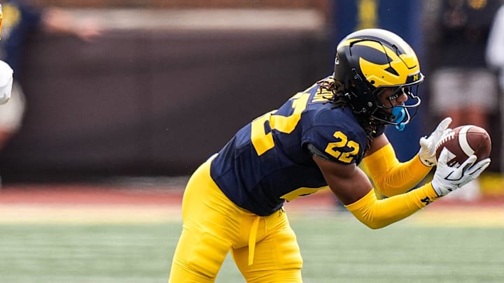 Michigan defensive back Elijah Dotson (22) intercepts a pass intended for Central Michigan wide receiver Langston Lewis (20) during the second half at Michigan Stadium in Ann Arbor on Saturday, Sept. 13, 2025.